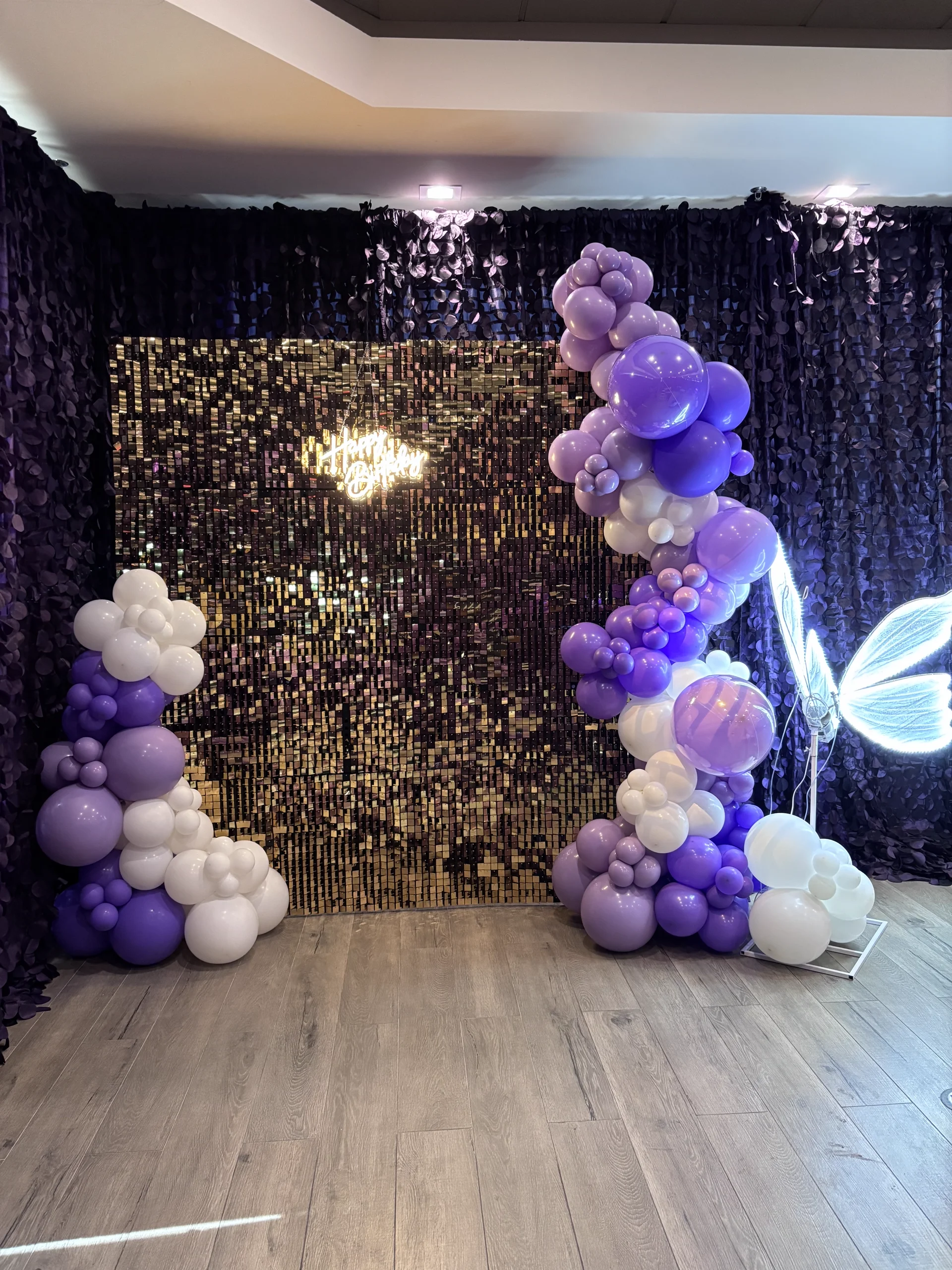 Styled backdrop rental with organic garland and acrylic sign